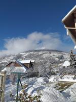 a view of a snowy mountain with a house at Le Bacchu Ber in Briançon