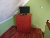 Televízia a/alebo spoločenská miestnosť v ubytovaní Nefelejcs Apartman