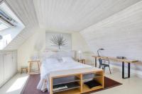 a bedroom with a bed and a desk at Maison de 3 chambres avec vue sur la mer jardin clos et wifi a Regneville sur Mer a 2 km de la plage in Regnéville-sur-Mer