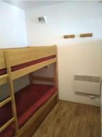 a small room with two bunk beds and a fan at Appartement de 2 chambres avec vue sur la ville piscine partagee et terrasse a La foux d&#39;Allos in La Foux
