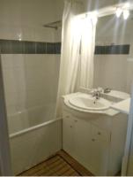 a white bathroom with a sink and a tub and a shower at Appartement de 2 chambres avec vue sur la ville piscine partagee et terrasse a La foux d&#39;Allos in La Foux