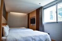 Talmud Hotel Tainanにあるベッド