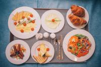 a tray with plates of food on a table at Jewel Green Mountain Hotel in Cairo