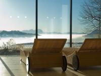 two chairs sitting in front of a large window at Wellnesshotel Linde in Sulzberg