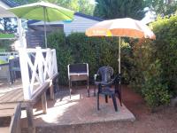 a patio with an umbrella and two chairs and an umbrella at Propriete de 2 chambres avec piscine partagee terrasse amenagee et wifi a Vic la Gardiole a 4 km de la plage in Vic-la-Gardiole