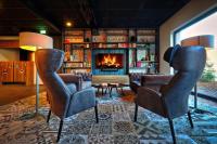 Una sala de estar con dos sillas y una chimenea. en Emils Hotel, en Pirmasens