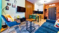 Televízia a/alebo spoločenská miestnosť v ubytovaní Apartament Biały Wilk - 5D Apartamenty