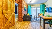 Televízia a/alebo spoločenská miestnosť v ubytovaní Apartament Biały Wilk - 5D Apartamenty