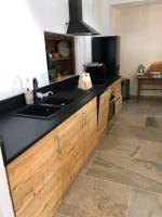 a kitchen with a sink and a black counter top at Appartement de 4 chambres avec jardin clos et wifi a Le Monetier les Bains in Le Monêtier-les-Bains
