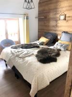 a bedroom with two beds with a furry animal on it at Appartement de 4 chambres avec jardin clos et wifi a Le Monetier les Bains in Le Monêtier-les-Bains