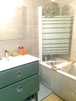 a bathroom with a sink and a bath tub with a sink at Appartement de 4 chambres avec jardin clos et wifi a Le Monetier les Bains in Le Monêtier-les-Bains