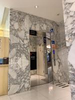 a marble lobby with elevators in a building at Chao She Hotel in Kaohsiung