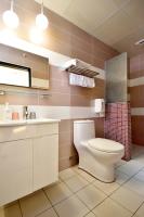 a bathroom with a toilet and a sink at Taitung Venice B&amp;B in Taitung City