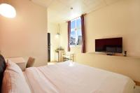 a bedroom with a bed and a flat screen tv at Taitung Venice B&amp;B in Taitung City