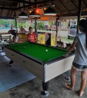 a group of people playing a game of pool at Lam Sai village hotel Koh Yao Noi in Ko Yao Noi