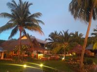 a resort with palm trees and tables and lights at Lam Sai village hotel Koh Yao Noi in Ko Yao Noi