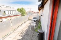 a balcony with a table and chairs on a building at Hotel Korotan in Vienna