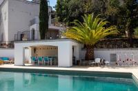 a pool in front of a house with a palm tree at Casa Di Angeli in Corbara