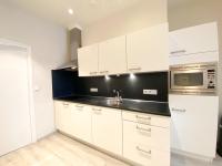 a kitchen with white cabinets and a microwave at Vakantiehuis in het Centrum van Domburg DO19 in Domburg