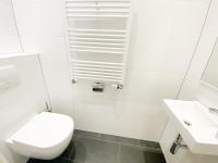 a white bathroom with a toilet and a sink at Vakantiehuis in het Centrum van Domburg DO19 in Domburg