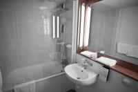 a bathroom with a sink and a mirror and a shower at Campanile Nîmes Sud - Caissargues in Caissargues