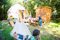 a group of children playing in a hammock in a yurt at Camping Mille Étoiles in Labastide-de-Virac