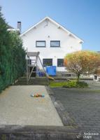 a white house with a playground in front of it at Le Loft in Stoumont