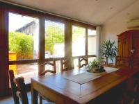 a dining room with a wooden table and windows at Appartement de 2 chambres avec jardin clos et wifi a Beblenheim in Beblenheim