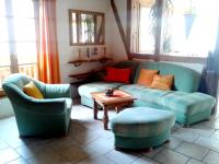 a living room with two couches and a table at Appartement de 2 chambres avec jardin clos et wifi a Beblenheim in Beblenheim