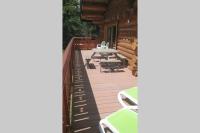a deck with a picnic table and chairs on a cabin at Chalet les SORBIERS, en rondins, classé 4****étoiles in Bolquere Pyrenees 2000