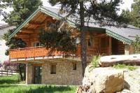 a log cabin with a porch and a deck at Chalet les SORBIERS, en rondins, classé 4****étoiles in Bolquere Pyrenees 2000