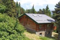 a log cabin with a solar roof on a hill at Chalet les SORBIERS, en rondins, classé 4****étoiles in Bolquere Pyrenees 2000