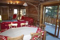 a screened in porch with a table and chairs at Chalet les SORBIERS, en rondins, classé 4****étoiles in Bolquere Pyrenees 2000