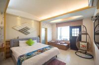 a bedroom with a large bed and a window at Lanyang Beach Villa in Wujie