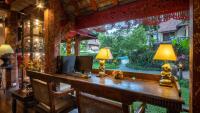 a home office with a desk with a computer on it at Yaang Come Village Hotel in Chiang Mai