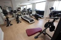 a gym with several treadmills and exercise bikes at Hotel Palladia in Toulouse