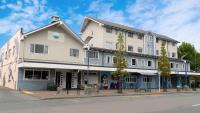 a large white building on the corner of a street at Based by the Lake in Taupo