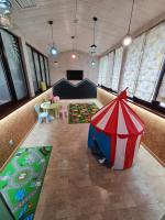 a living room with a table and an umbrella at SPA Hotel Galera in Kyiv