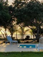 two blue chairs sitting next to a swimming pool at Pousada São Francisco in Cumuruxatiba