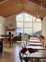 a dining room with tables and a large window at Alishan Tea Garden B&amp;B in Fenqihu