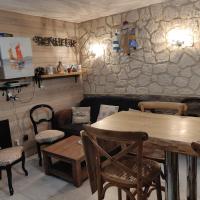 a restaurant with a table and chairs and a stone wall at Chez Isa in Yport