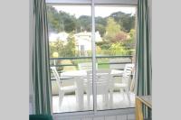a white table and chairs on a balcony at Studio - 700m plage port - 200m golf - wifi - piscine in Pornic