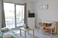 a living room with a table and a dining room at Studio - 700m plage port - 200m golf - wifi - piscine in Pornic