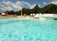 a large swimming pool with a water slide at Bastide De Mazan in Riez