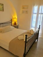 A bed or beds in a room at Anthos House