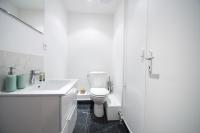 a white bathroom with a toilet and a sink at Luxury flat- Eiffel tower in Paris