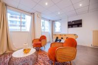 a room with orange chairs and a table and a crib at Luxury flat- Eiffel tower in Paris