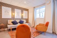 a living room with a couch and chairs and a window at Luxury flat- Eiffel tower in Paris