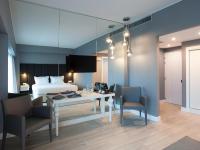 a hotel room with a bed and a table and chairs at Lutecia Smart Design Hotel in Lisbon