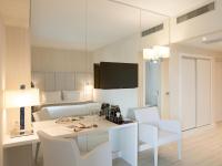 a room with a table and chairs and a bed at Lutecia Smart Design Hotel in Lisbon